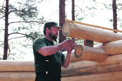 Kirvesmies Jussi Leponiemi tekee työnsä tarkasti. Keittokodan salvokset ovat niin tiukalla, ettei edes voipaperi mahtuisi väliin.